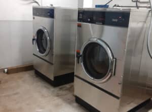 Commercial laundry machine header